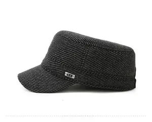 Detalle de la tela de sarga gris y el emblema metálico F-S en la gorra militar plana
