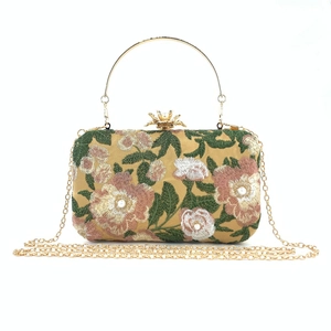 Detailed embroidery view of floral pattern and pearl beads on the elegant evening clutch