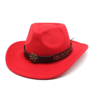 Detail of red western hat with leather band, gold studs and bronze floral buckle