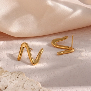 Minimalist gold Z-shaped stainless steel wave stud earrings on elegant silk background