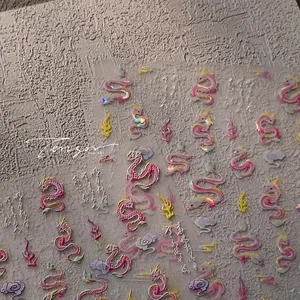 Close-up of pink laser dragon nail decals with Chinese New Year motifs and clouds