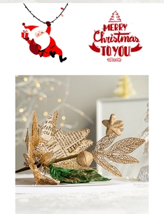 Close-up of glittery gold Christmas poinsettia flower with vintage newspaper print leaves