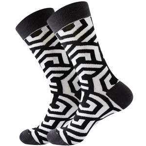 Detail of crew socks with black and white geometric patterns on a clean white background