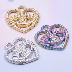 Detail of 18k plated heart-shaped eye pendants in gold, silver, and rainbow finishes
