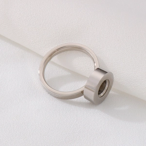 Minimalist silver stainless steel ring for DIY jewelry displayed on white fabric