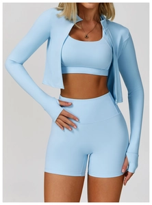 Detail of light blue high-waist shorts and sports bra with premium quick-dry texture