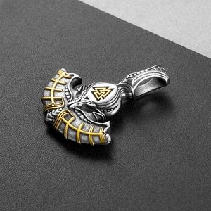 Macro detail of silver stainless steel Viking axe pendant with golden Valknut symbol