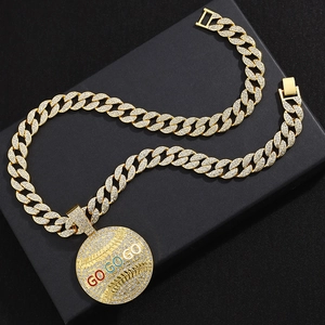 Macro detail of iced-out GO GO GO pendant with colorful enamel on gold Cuban link chain