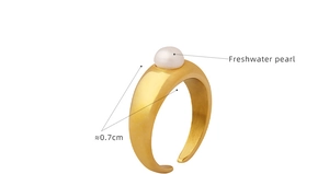 Detailed macro view of 0.7cm freshwater pearl on gold minimalist open ring