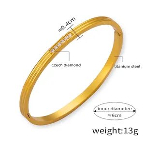 Detail showing 0.4cm width and 6cm diameter of the gold-plated rhinestone titanium bangle