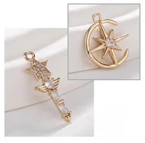 Macro detail of gold plated star scepter and moon charms with sparkling zircon inlays