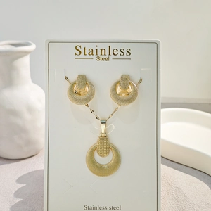 Detailed view of vintage gold geometric necklace and earrings set in stainless steel