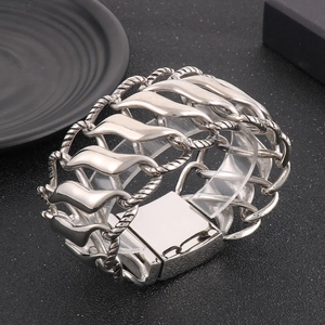 Macro shot of polished silver twist chain bracelet with square metal locking clasp