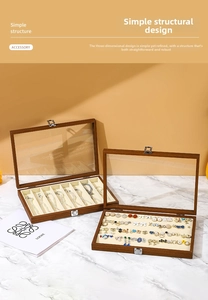 Macro shot of walnut wood jewelry box featuring clear glass lid and soft velvet interior