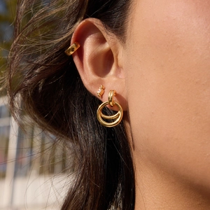 Three-piece 18K gold plated earring set with white zircon stones on model's ear