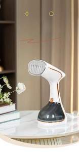 Detail view of the portable handheld steam iron with stainless steel nozzle and grey water tank