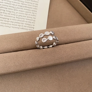 Detailed view of silver layered pearl ring with sparkling zircon in a luxury jewelry tray
