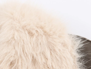 Macro detail of soft light beige faux fur texture on fashionable reversible coat