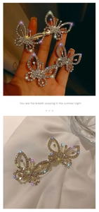 Close-up of sparkling rhinestone bow hair clip on elegant white silk background