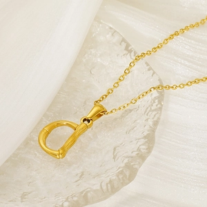 18k gold plated stainless steel necklace featuring a textured letter D bamboo pendant