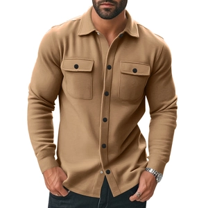 Detail of tan casual jacket featuring double chest pockets and black button fastenings