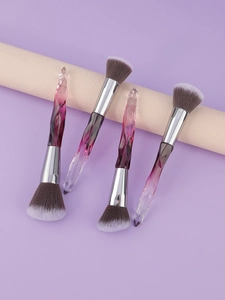 Detail of gradient purple crystal handle makeup brushes with soft synthetic bristles