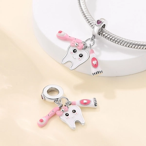 Silver plated tooth and toothbrush charms on a sleek chain bracelet for dental themes