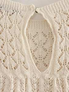 Dettaglio della trama in maglia traforata e chiusura con bottone color crema