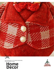 Close-up of a Christmas gnome doll featuring red knit vest and faux pearl buttons detail