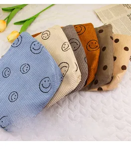 Detailed texture of corduroy makeup bags with smile face and polka dots in multiple colors