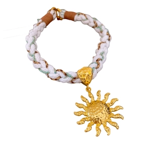 Ethnic bohemian woven sun pendant necklace with gold sun charm and white cord cord design