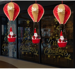 Close-up of Santa Claus in a red and gold hot air balloon hanging for Christmas decor