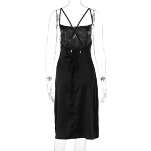 Detailed back view of a black satin midi dress featuring elegant crisscross lace-up straps