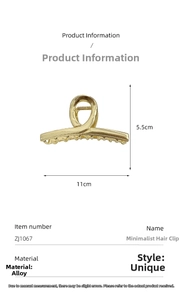 Detail view of large gold alloy shark hair clip with dimensions 11cm by 5.5cm