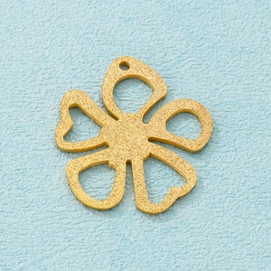 Macro shot of matte gold plated hollow five-petal flower pendant for DIY jewelry making