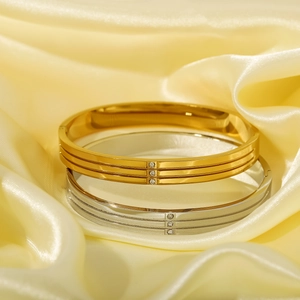Luxurious gold and silver stainless steel bangles with triple line design and crystals