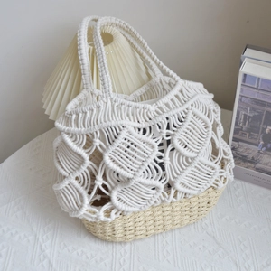 Close-up of white macrame cotton rope stitching and beige straw woven bucket bag base