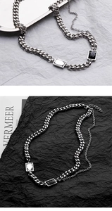 Detail of silver Cuban chain necklace with rectangular black and clear gemstones