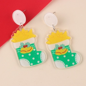 Detailed view of Christmas stocking earrings with green acrylic base and red berry accents