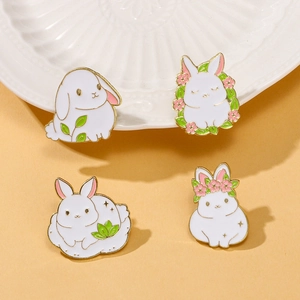 Set of four cute white rabbit enamel pins with pink flowers and gold trim for bags