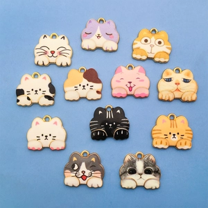 Set of 11 colorful enamel cat charms in various cute patterns on a light blue background