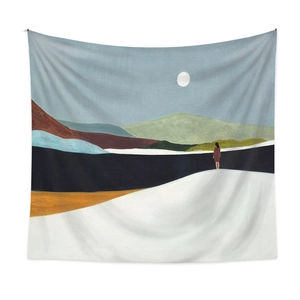 Detail of bohemian tapestry featuring minimalist winter mountain and moon illustration