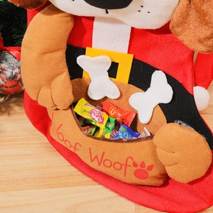 Red knitted Christmas stocking with plush dog design and Woof Woof embroidery on wood floor