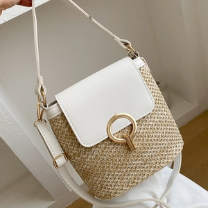 Minimalist straw and leather patchwork beach crossbody bag with a round gold metal lock
