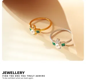 Detailed view of gold and silver twisted titanium rings with pearls and zircon stones