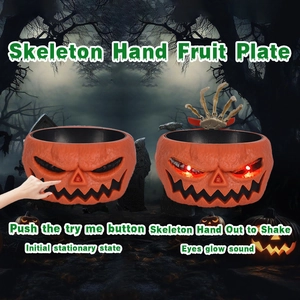 Animated Halloween pumpkin fruit bowl with glowing red eyes and moving skeleton hand