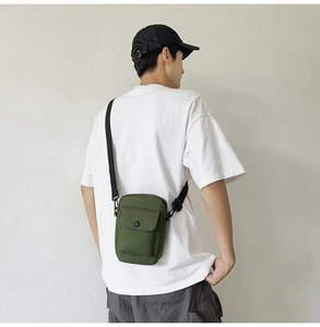 Army green canvas messenger bag shown on model for street style and daily wear