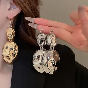 Exaggerated hammered metal layered earrings in polished gold and silver finish