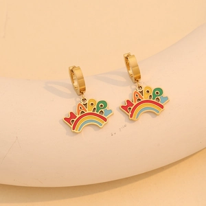 Gold hoop earrings with happy rainbow charms displayed on a minimalist beige stand