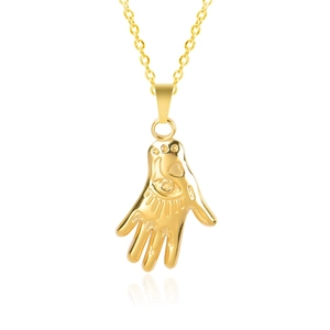 Detailed view of golden Hamsa Hand pendant featuring intricate eye and heart patterns